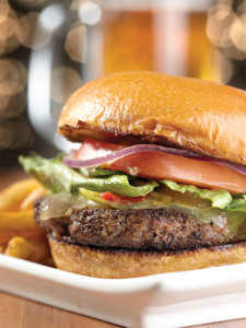 A tasty hamburger with lettuce, tomatoes and onion