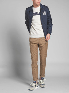 Young man wearing jacket, shirt, and pants from Carhartt