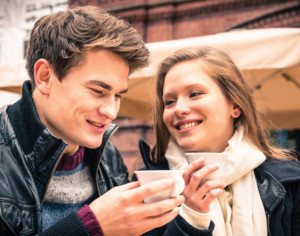 Young man and woman having hot coffee