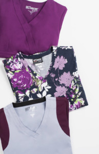 Scrubs in shades of dark purple, patterned purple, and lilac