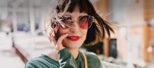 Young brunette girl in sunglasses, talking on her cell phone