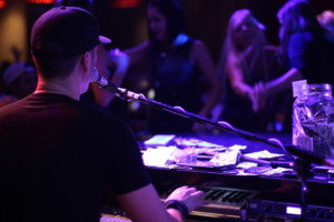 Man playing piano and singing into microphone