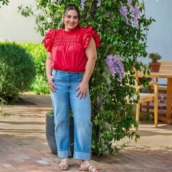 Woman in red top and blue jeans