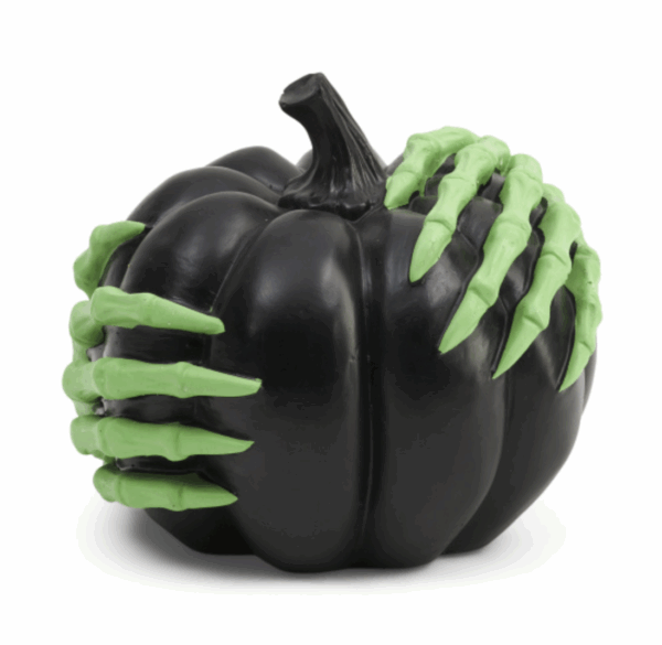 Glow in the dark black pumpkin with green witches hands around it