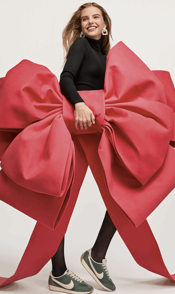 Woman wearing sneakers with giant Christmas bow