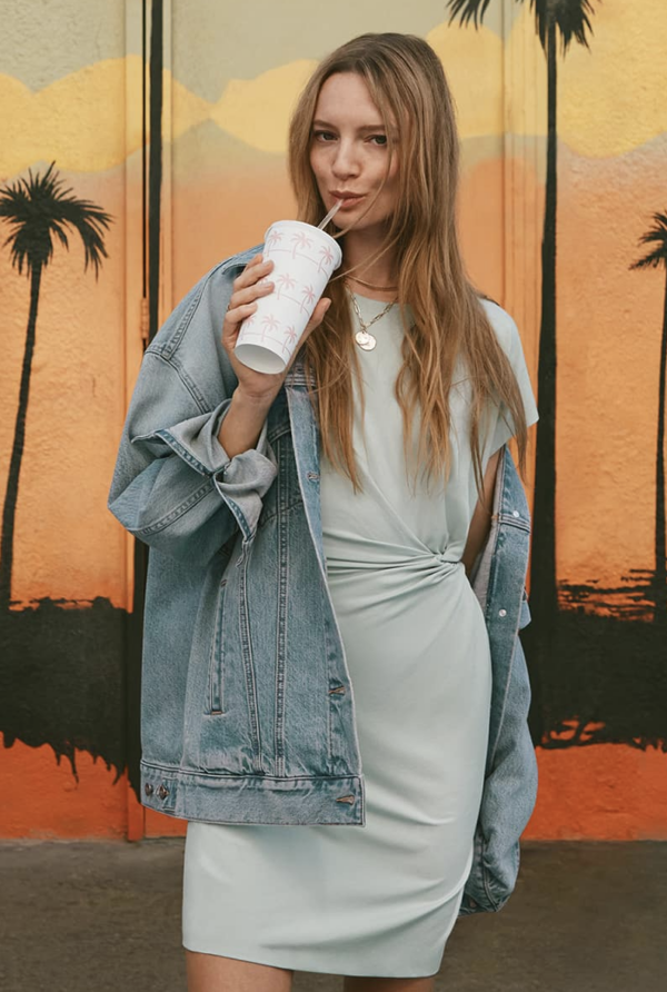 Girl wearing denim jacket over light blue dress
